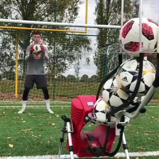 Goalkeeper catching a football delivered by a POWAPASS machine